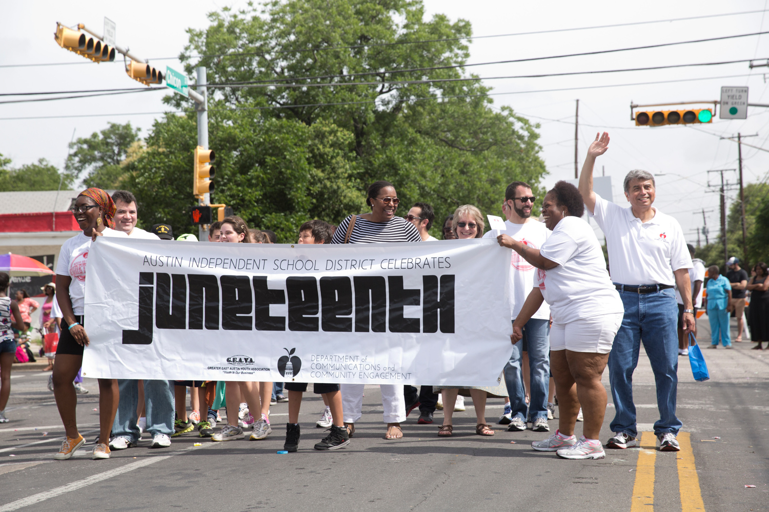 parade in Austin, Texas includes crowds dancers politicians